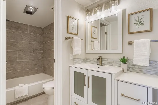 a bathroom with a sink a toilet and bathtub