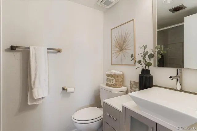a bathroom with a toilet sink and shower
