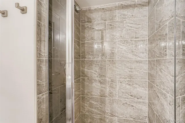 a bathroom with a glass door shower