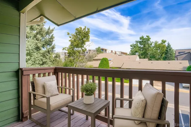 a view of a two chairs in the balcony
