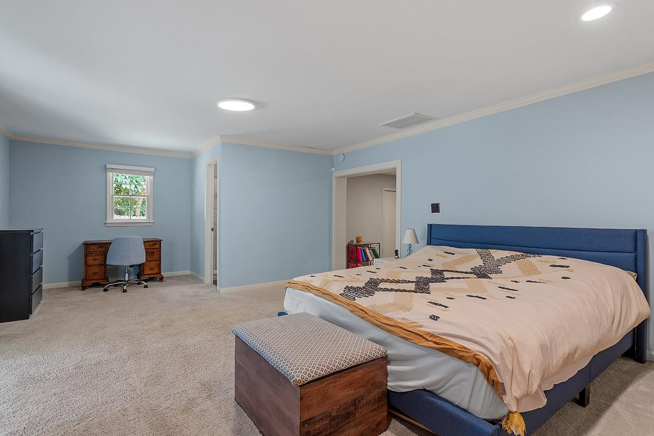 2816 Newark Drive Raleigh, NC 27610 - Photo 21 of 33 a bed sitting in a bedroom next to a window