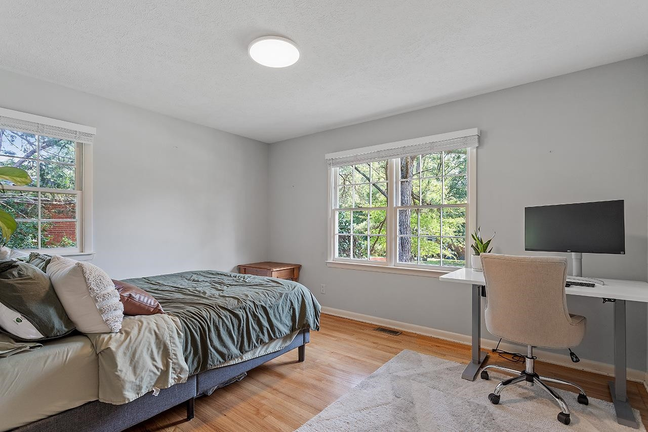 2816 Newark Drive Raleigh, NC 27610 - Photo 25 of 33 a bed sitting in a bedroom next to a window and work place