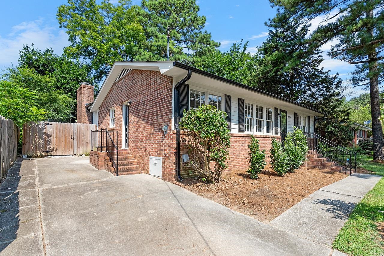 2816 Newark Drive Raleigh, NC 27610 - Photo 6 of 33 a front view of a house with a yard and potted plants