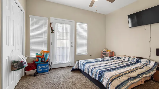 a bed sitting in a bedroom next to a window