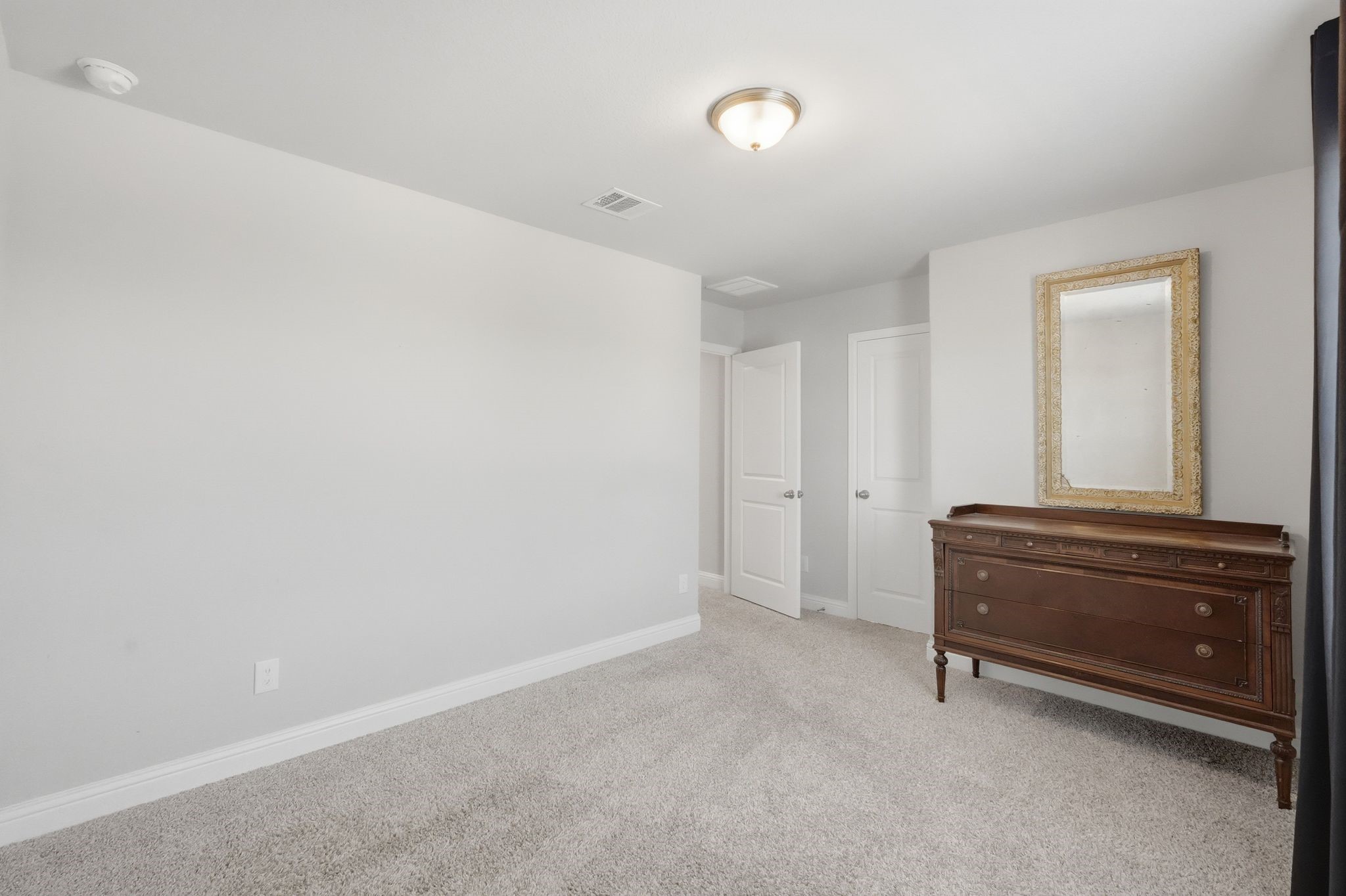 2809 Andante Green Drive Spring, TX 77386 - Photo 36 of 50 a room with a dresser and a mirror