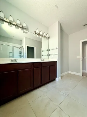 a bathroom with a double vanity sink and a mirror