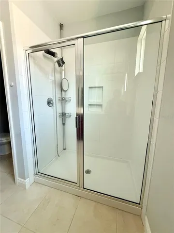 a bathroom with a glass shower door