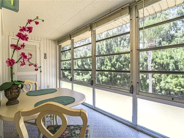 a front view of a dining room with furniture window and outside view