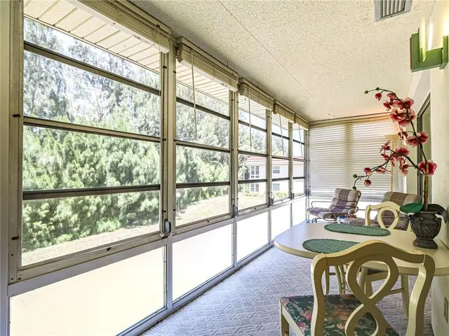 a dining room with furniture a chandelier and wooden floor