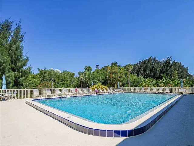 a view of a swimming pool with a yard