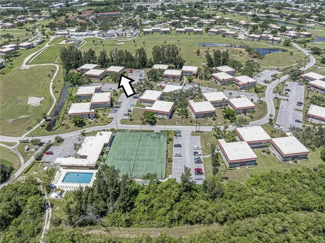 an aerial view of residential houses with outdoor space and lake view