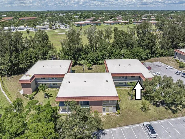 an aerial view of a house with a garden and lake view