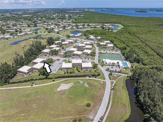 an aerial view of residential houses with outdoor space and swimming pool
