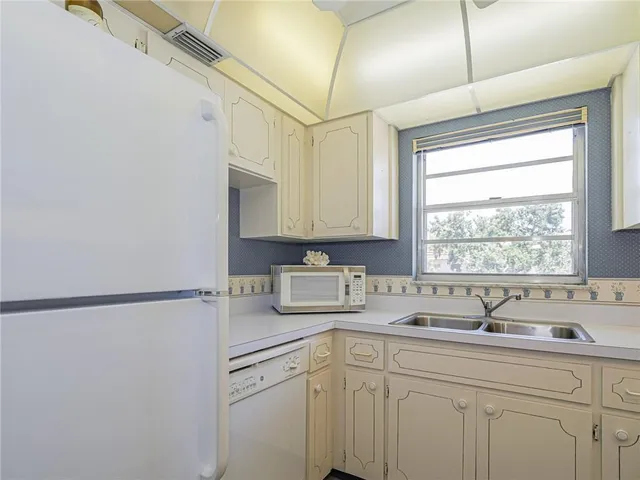 a kitchen with a sink cabinets and window