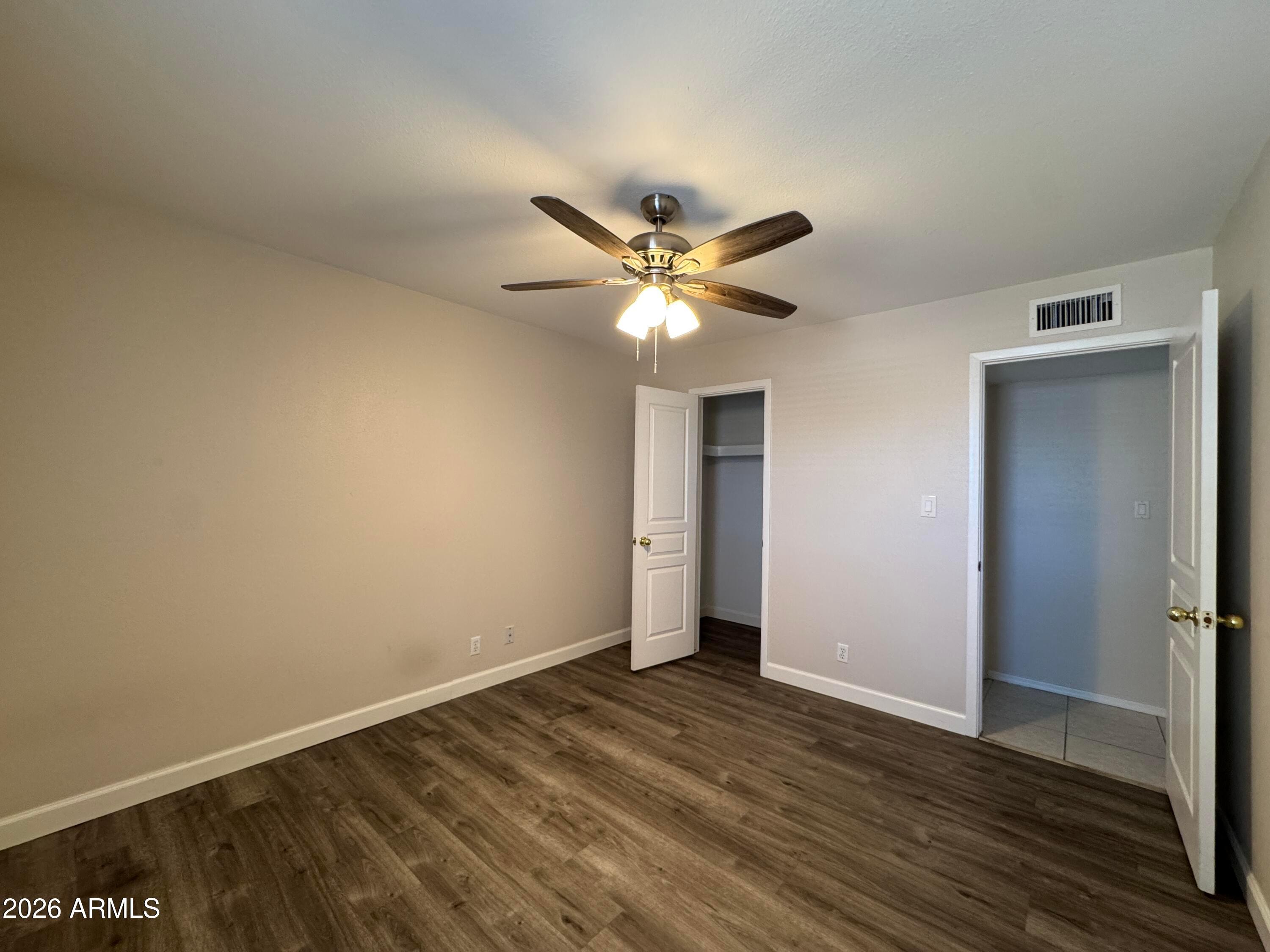 6317 East McLellan Road Mesa, AZ 85205 - Photo 15 of 28 a view of an empty room with wooden floor