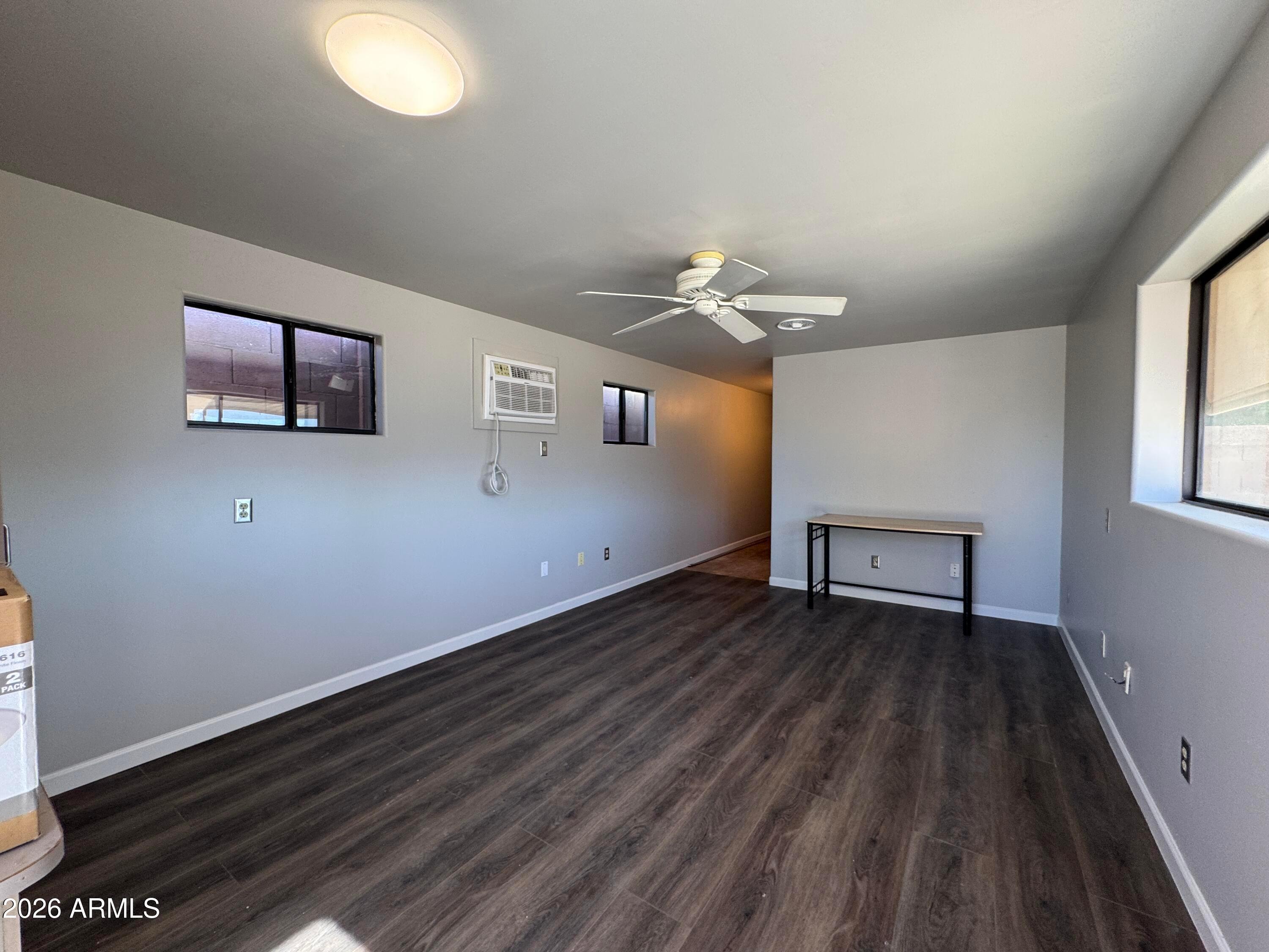 6317 East McLellan Road Mesa, AZ 85205 - Photo 22 of 28 a view of an empty room with wooden floor and a window