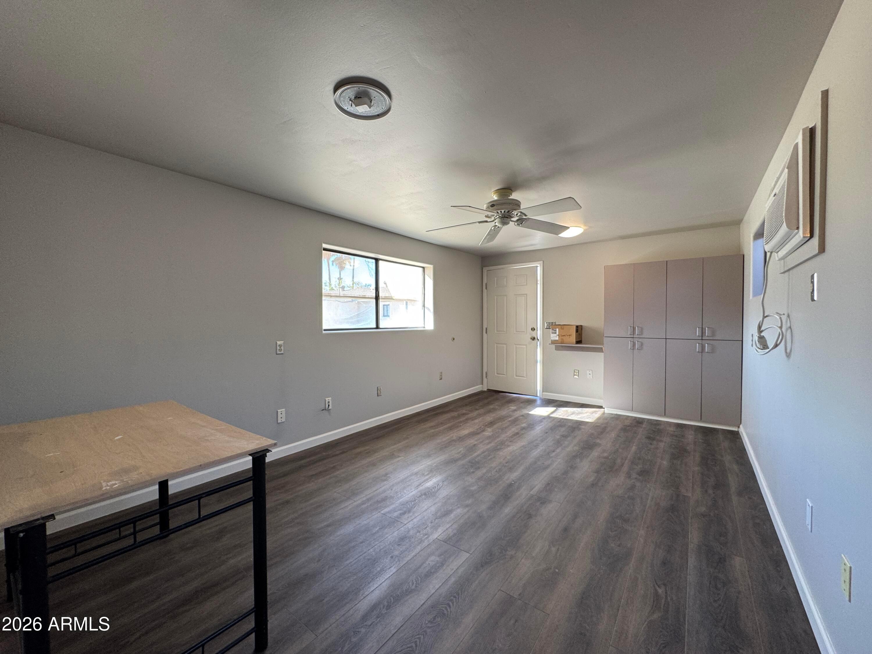6317 East McLellan Road Mesa, AZ 85205 - Photo 23 of 28 a view of empty room with wooden floor and window
