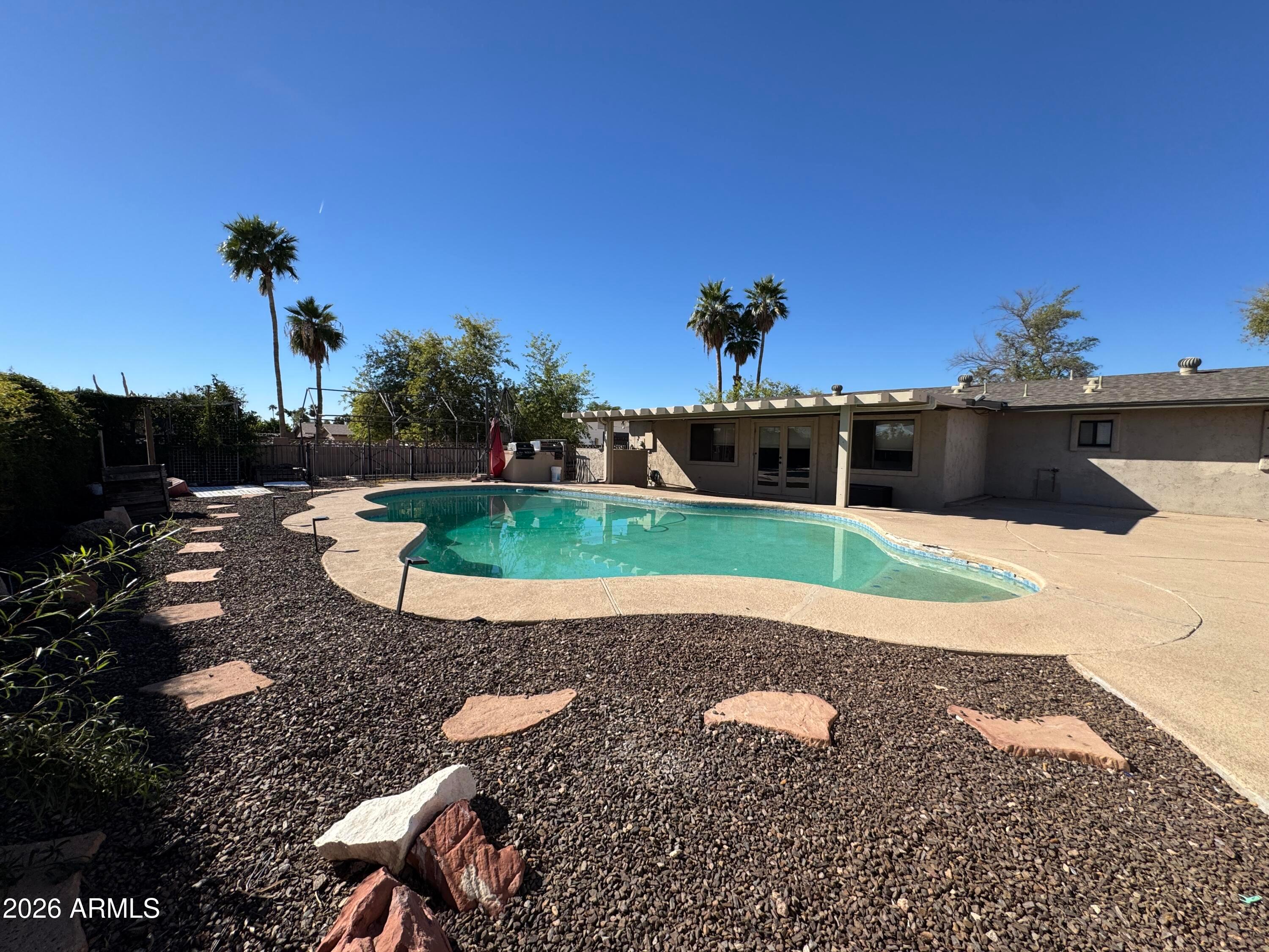 6317 East McLellan Road Mesa, AZ 85205 - Photo 26 of 28 a view of a swimming pool with a yard
