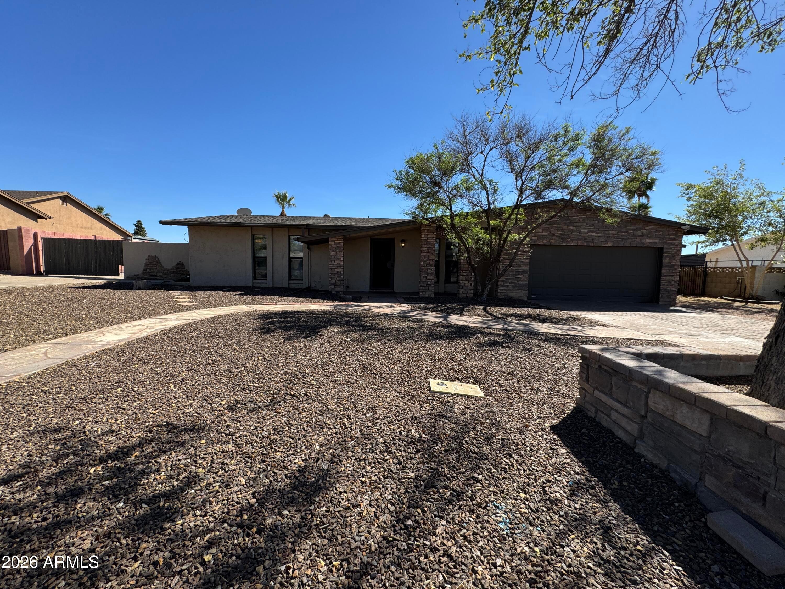 6317 East McLellan Road Mesa, AZ 85205 - Photo 3 of 28 a backyard of a house with lots of green space