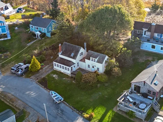 an aerial view of a house with garden space and houses