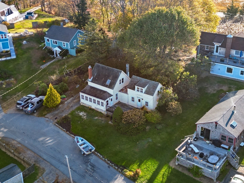 an aerial view of a house with garden space and houses