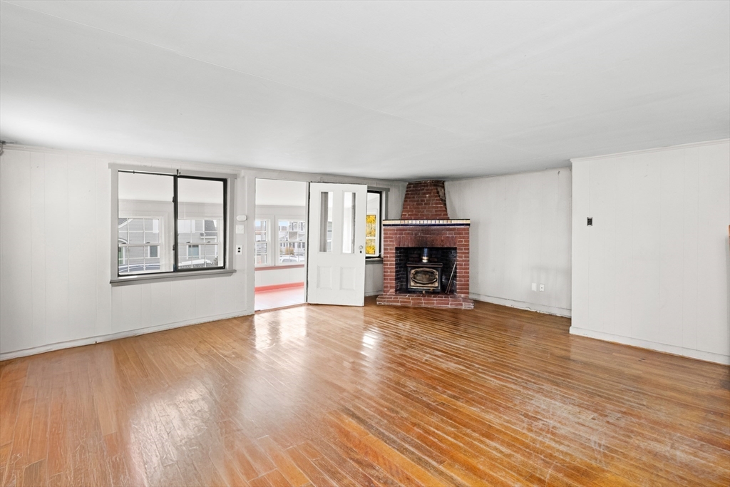 15 Eagle Hill Road Ipswich, MA 01938 - Photo 12 of 41 wooden floor fireplace and windows in an empty room