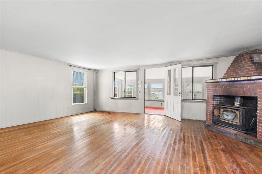15 Eagle Hill Road Ipswich, MA 01938 - Photo 13 of 41 wooden floor fireplace and windows in an empty room