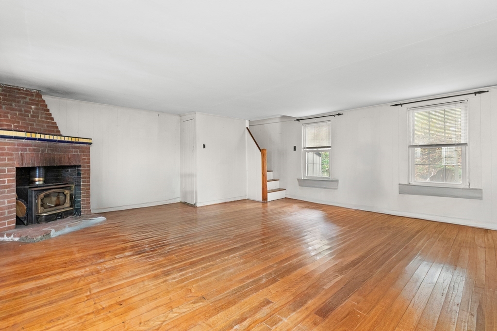 15 Eagle Hill Road Ipswich, MA 01938 - Photo 14 of 41 a view of an empty room with wooden floor fireplace and a window