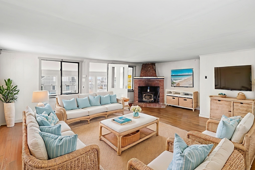 15 Eagle Hill Road Ipswich, MA 01938 - Photo 15 of 41 a living room with furniture flat screen tv and a fireplace