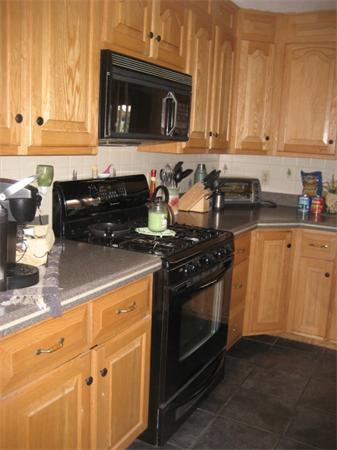 34 Hillandale Road Ashburnham, MA 01430 - Photo 3 of 15 a kitchen with granite countertop a stove top oven microwave and cabinets