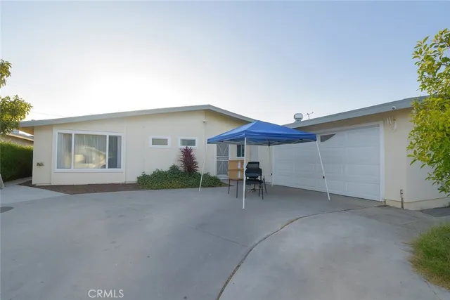a backyard of a house with table and chairs