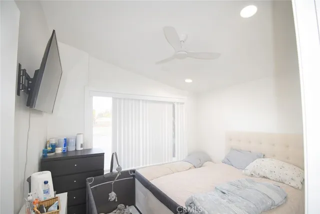 a bedroom with two bed and a window