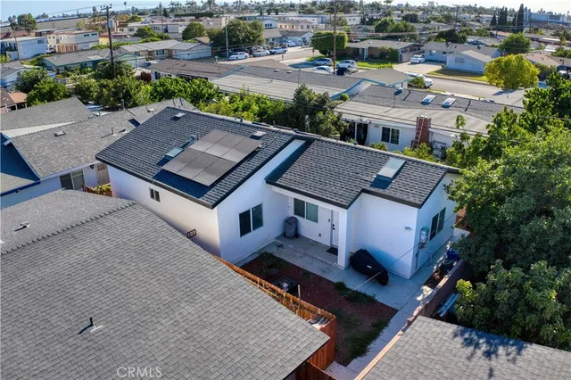 an aerial view of a house with a yard garage and lake view