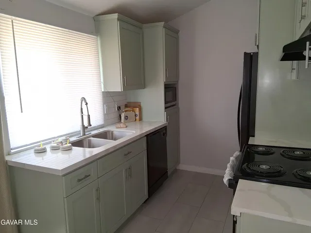 a kitchen with a refrigerator and a sink