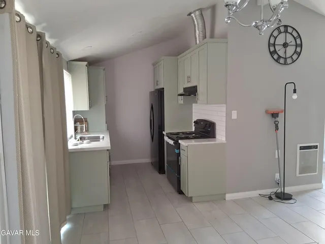 a utility room with cabinets and washer dryer