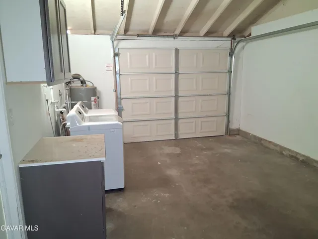 a utility room with a sink washer and dryer