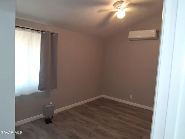 a room with a window and wooden floor