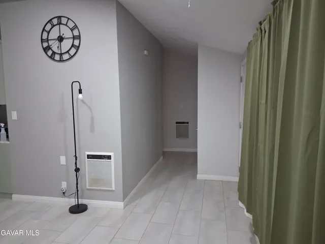 a view of a kitchen with fridge and a sink
