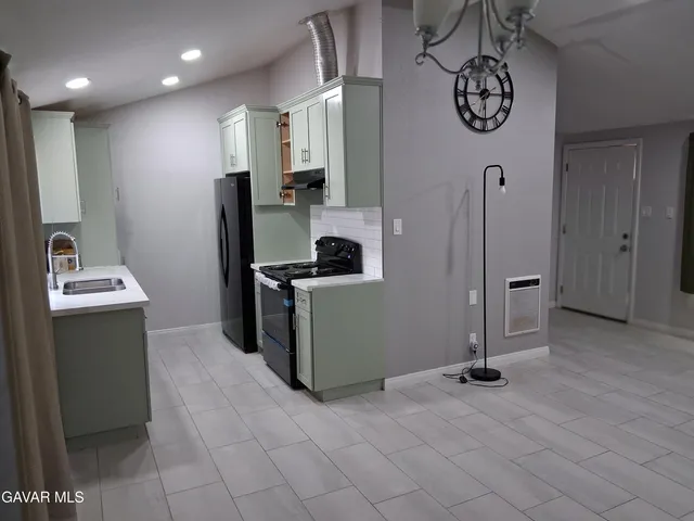 a stove top oven sitting inside of a kitchen