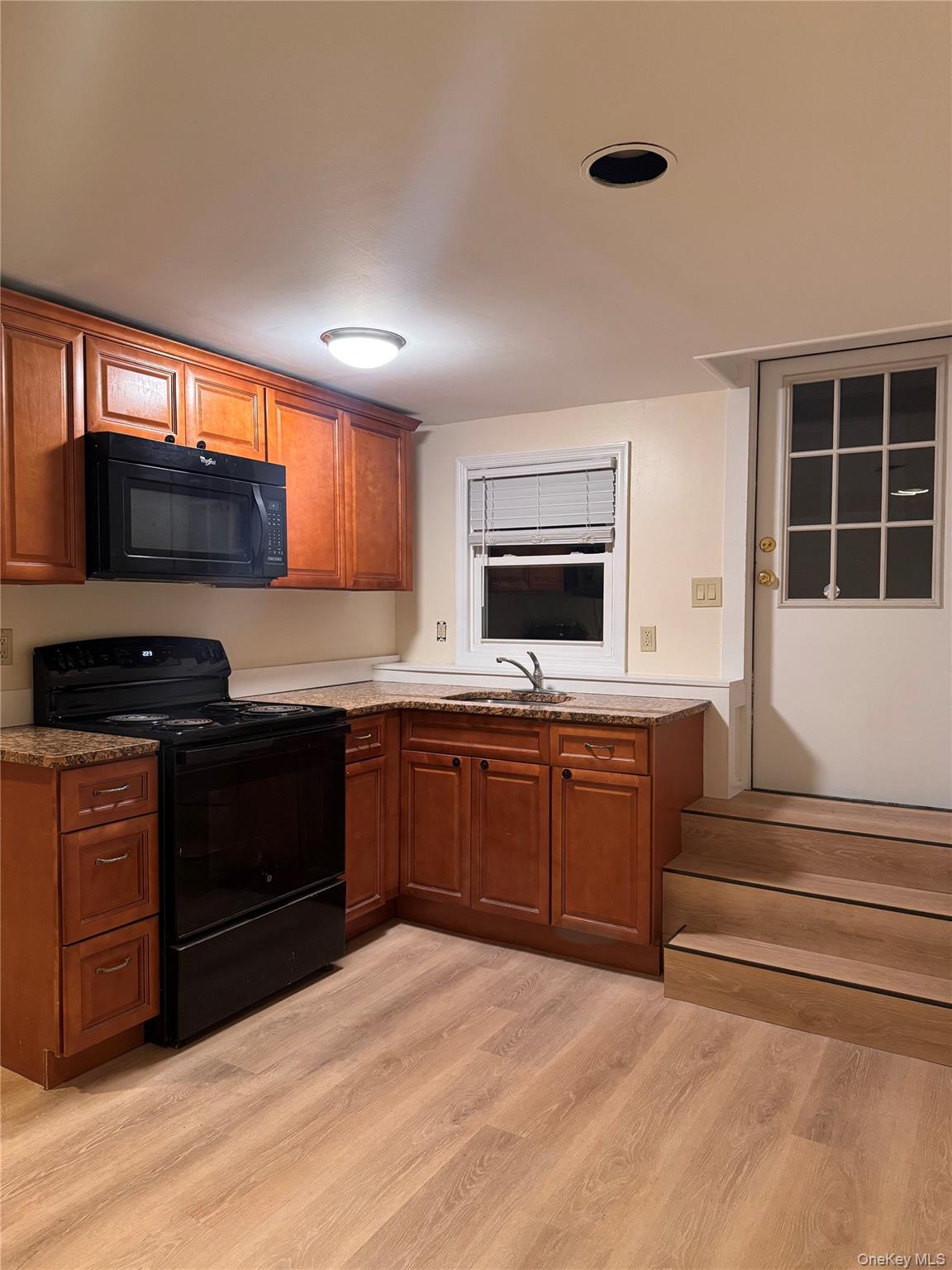 a kitchen with stainless steel appliances granite countertop a stove and a sink