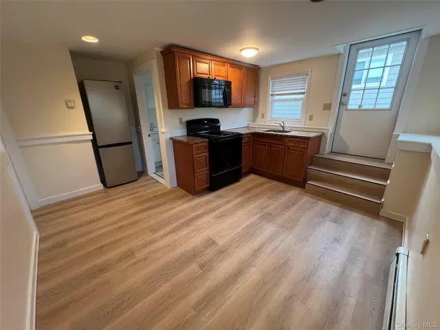a kitchen with stainless steel appliances a refrigerator and a sink