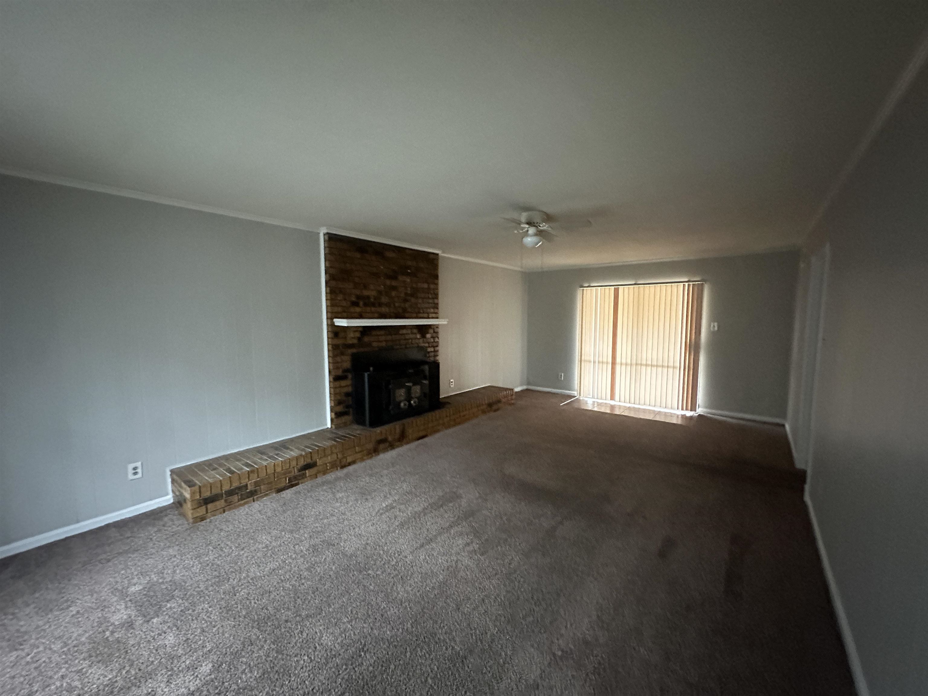 2111 Rock Ridge Road Memphis, TN 38134 - Photo 11 of 20 an empty room with a fireplace and window