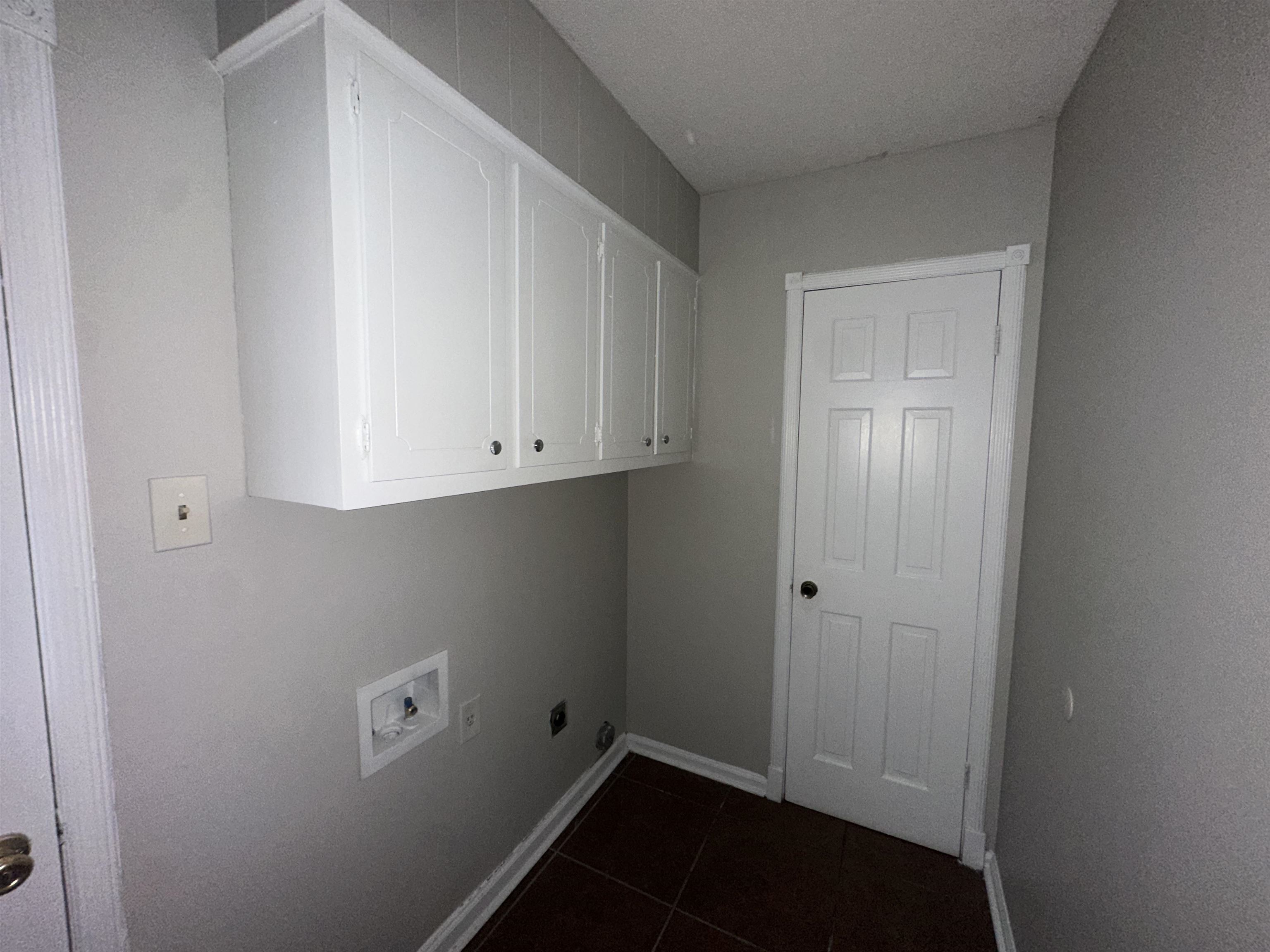 2111 Rock Ridge Road Memphis, TN 38134 - Photo 16 of 20 Washroom with cabinet space, hookup for a washing machine, dark tile patterned flooring, and electric dryer hookup
