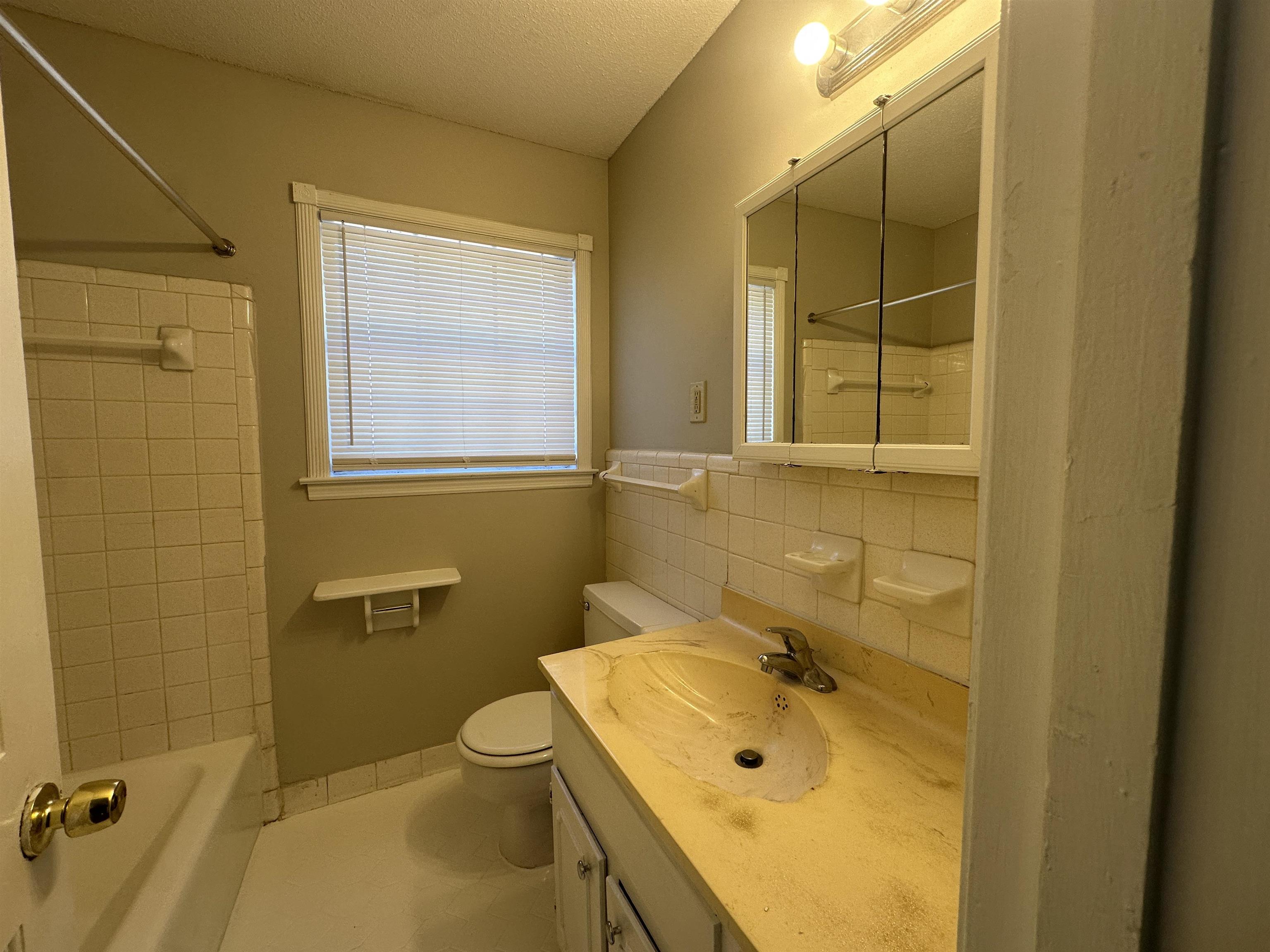 2111 Rock Ridge Road Memphis, TN 38134 - Photo 17 of 20 a bathroom with a sink mirror toilet and shower