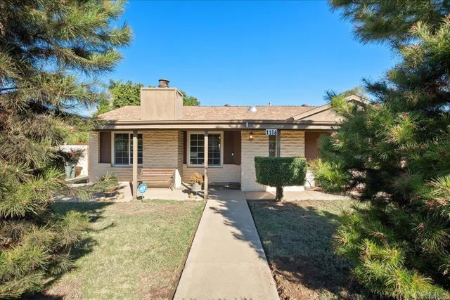 a front view of a house with a garden and patio