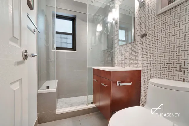 a bathroom with a toilet a sink and shower