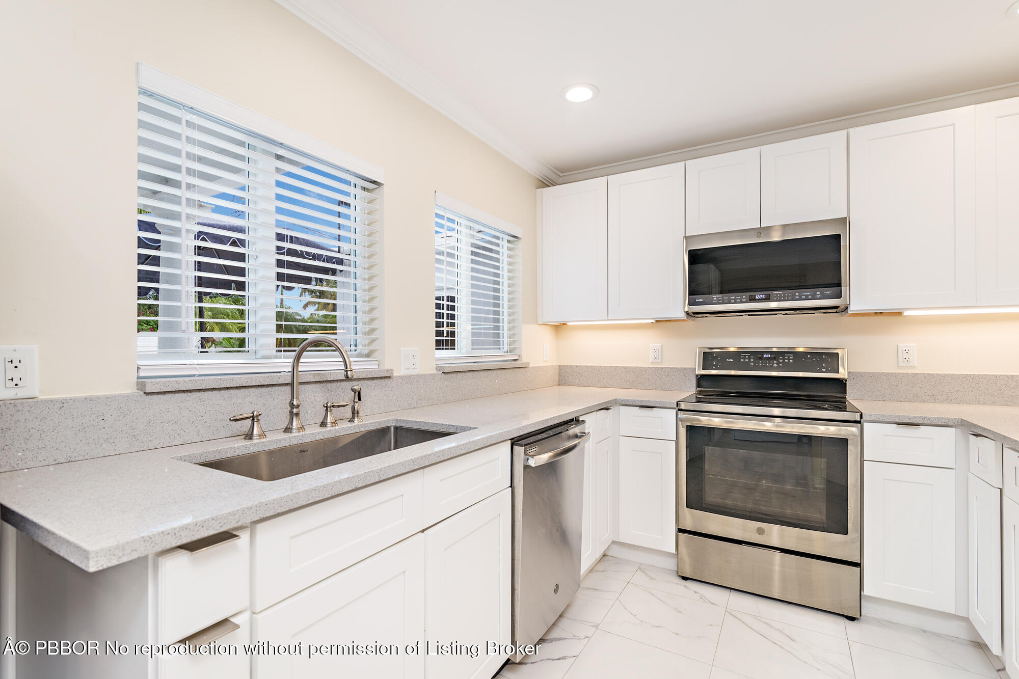 369 Valley Forge Road West Palm Beach, FL 33405 - Photo 9 of 19 a kitchen with stainless steel appliances a stove sink and microwave