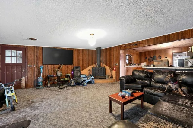 a living room with furniture a air conditioner and a table