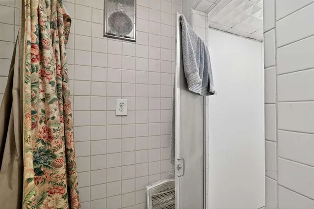 a bedroom with bed and wall painting