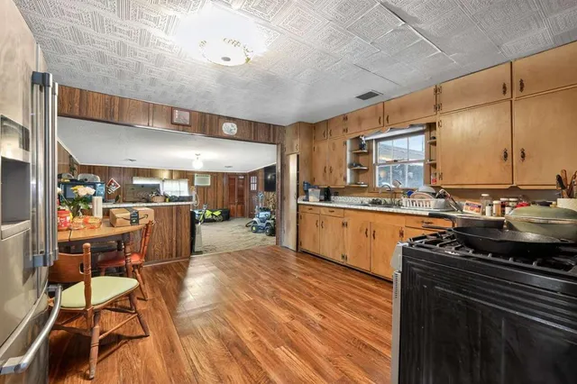 a kitchen with stainless steel appliances granite countertop a sink and cabinets